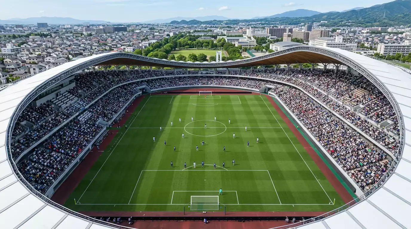 Vista aérea de un estadio de fútbol japonés con los jugadores de ambos equipos en el campo